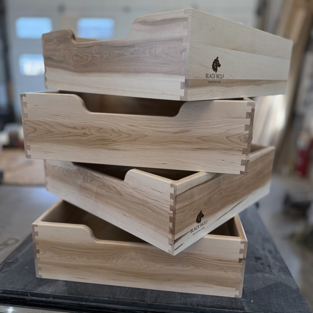 Detail view of maple drawer boxes, highlighting dovetail joinery.