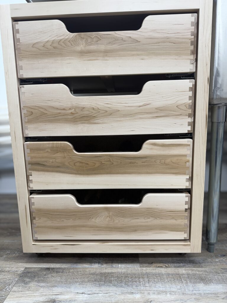 Maple drawer boxes in moveable storage cabinet.
