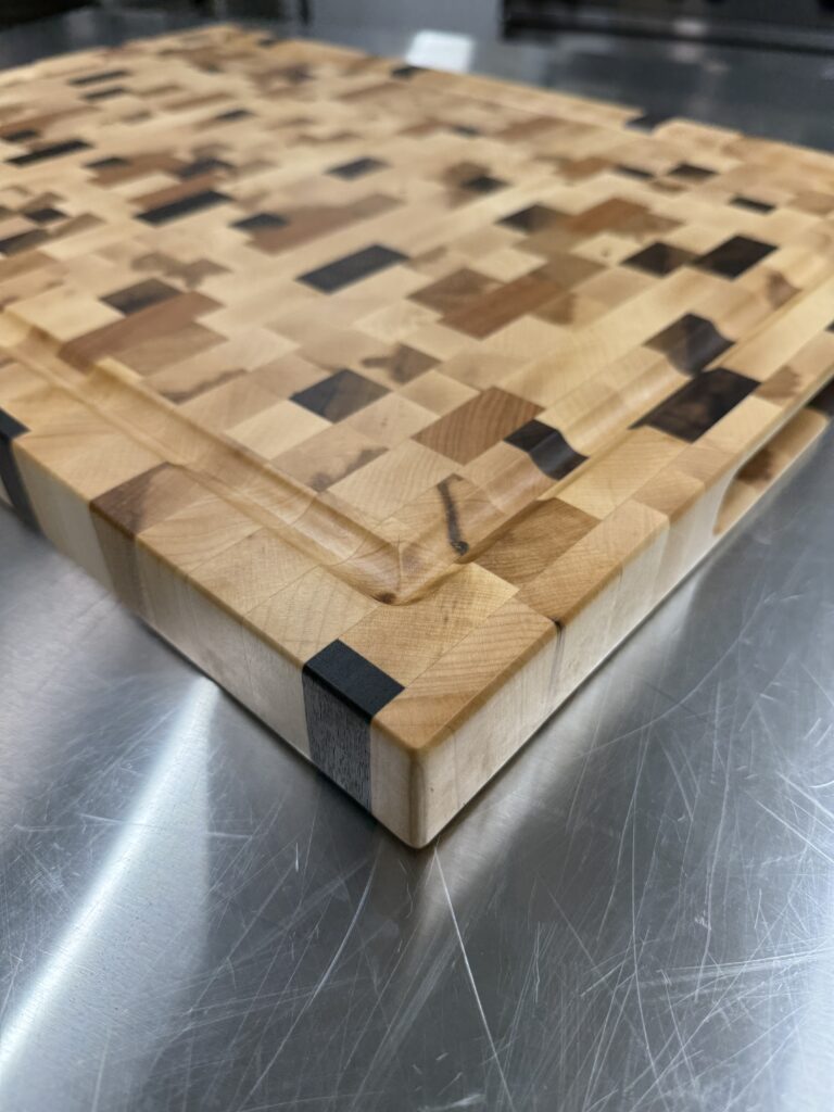  Detail view of maple end‑grain cutting board featuring walnut and cherry accents