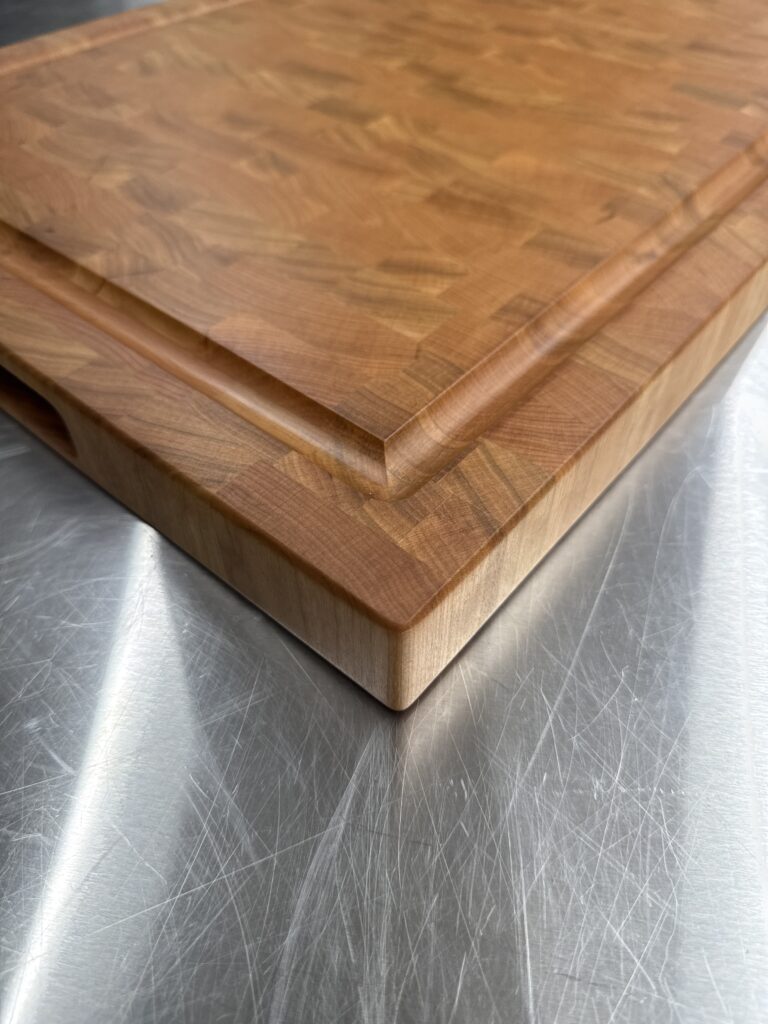 close up of cutting board to highlight grain pattern and juice groove.
