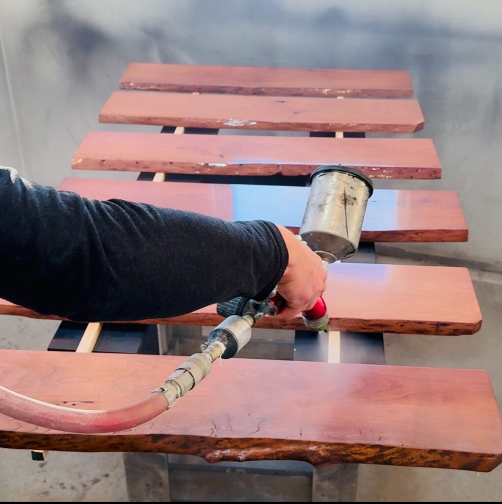 Image of clear coat being applied to a set of floating shelves.