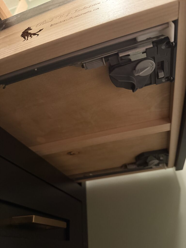Underside of drawer box showing soft close slides.