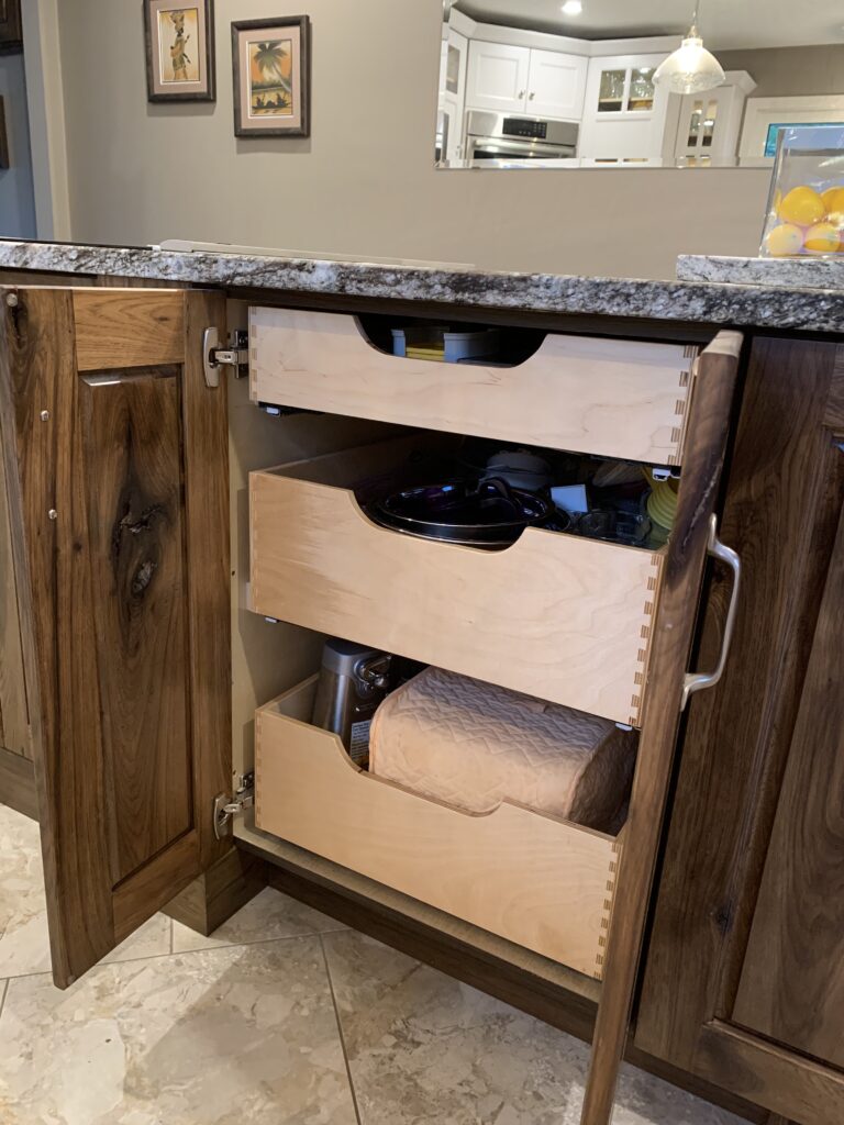 Drawer box pullouts mounted in cabinet.