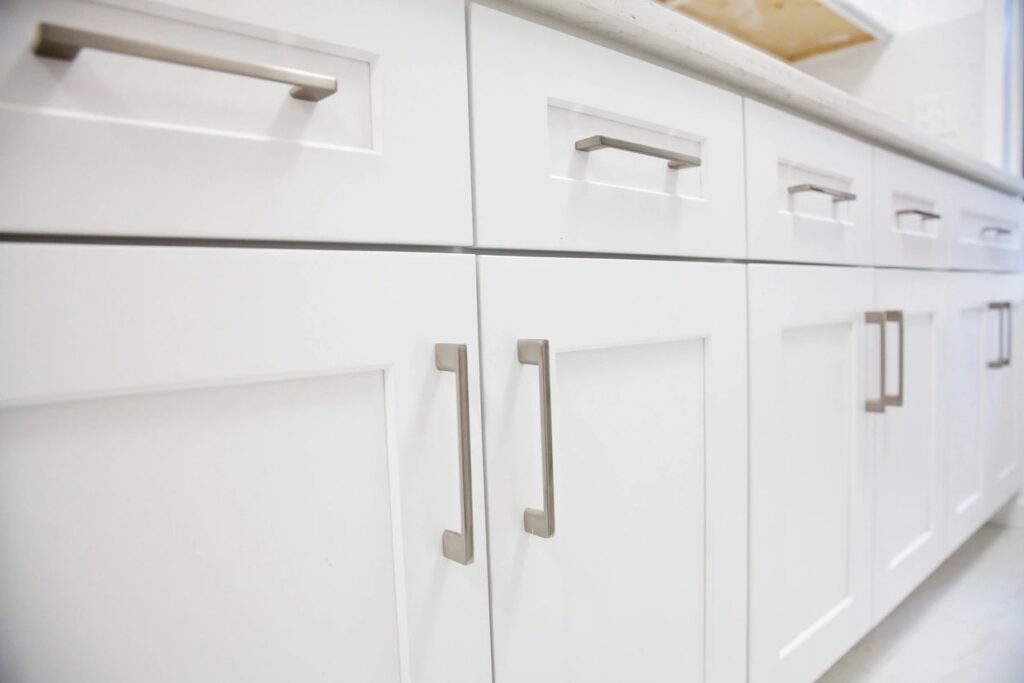 White cabinetry with satin nickel headwear