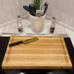 Overhead shot of cherry cutting board with smooth prep surface and routed groove