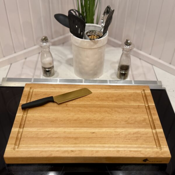 Overhead shot of cherry cutting board with smooth prep surface and routed groove