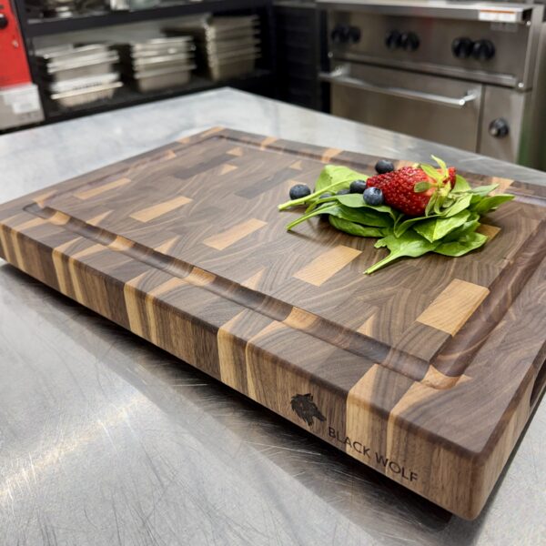 Walnut end grain cutting board, Black Wolf Industries logo engraved on edge